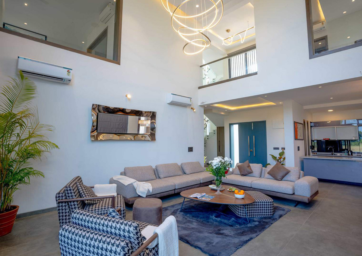 Wide-angle view of a spacious living room with modern décor and high ceilings