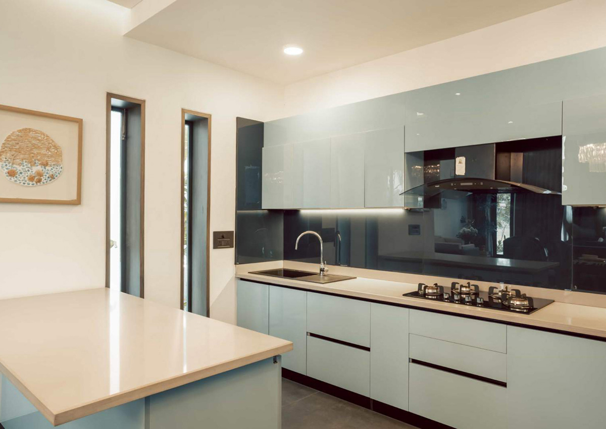 Sleek modern kitchen with glossy cabinets, island counter, and built-in appliances