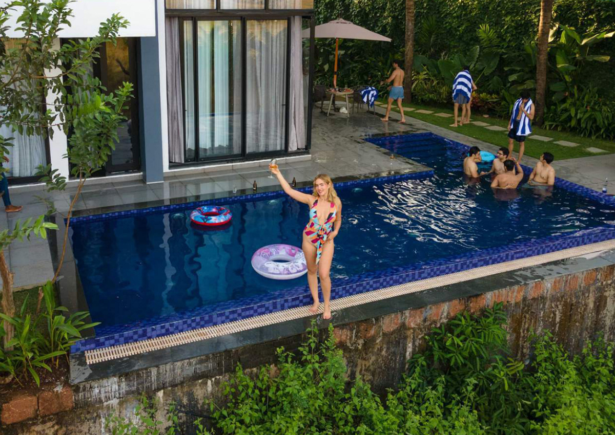 Guests enjoying a private pool surrounded by lush tropical greenery