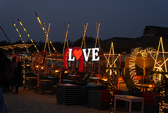 Illuminated beach shacks at Calangute Beach at night