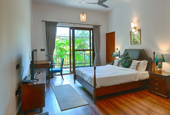 Spacious villa bedroom with balcony view