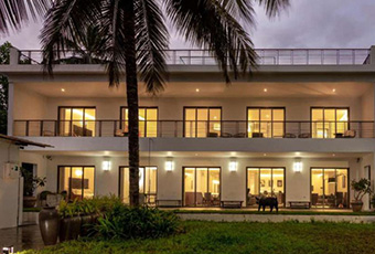 Luxury villa exterior illuminated at night