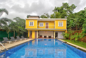 Yellow villa with large outdoor swimming pool