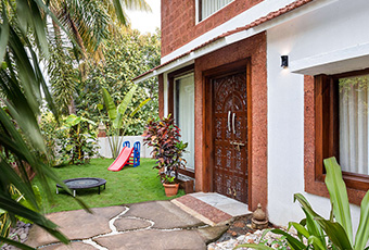 Heritage villa entrance with landscaped garden and lawn